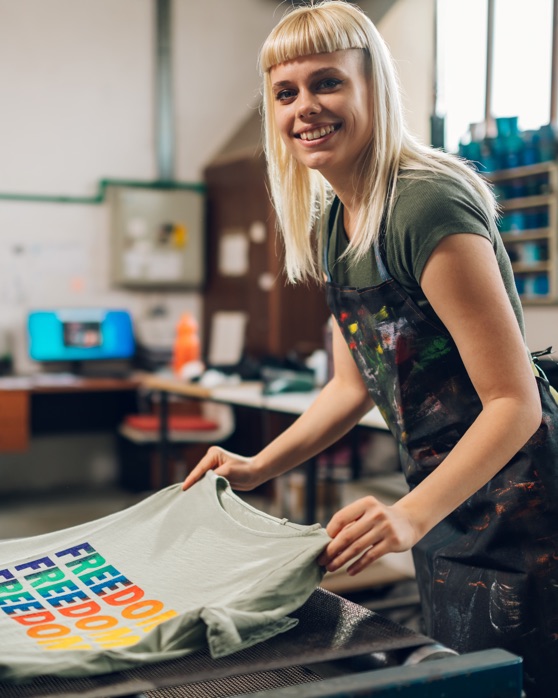 Screen printer pulling shirt from dryer